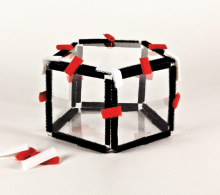 Photo shows a pentagon constructed from Geometro tiles with hook-and-loop material markers, as described.