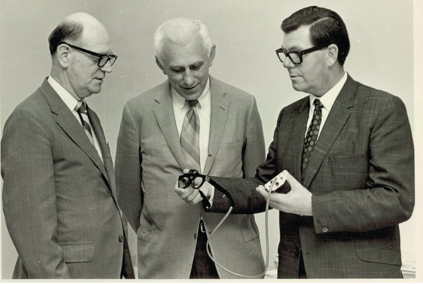 Eichorn, Blasch, and Kay looking at a Sonic Guide, ca. 1970