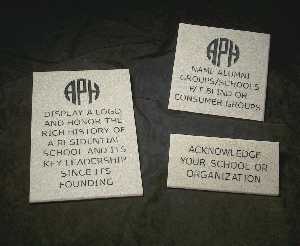 Three stones of different sizes. The largest stone has the APH logo and this engraved text: "Display a logo and honor the rich history of a residential school and its key leadership since its founding." The medium sized stone has the APH logo and this text: "Name Alumni Groups/Schools f/t Blind or Consumer Groups."  The small stone reads simply "Acknowledge your school or organization."
