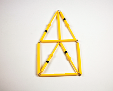 Photo shows the rod model of the triangular prism in 2-D, straight on view, with variable length edges elongated.