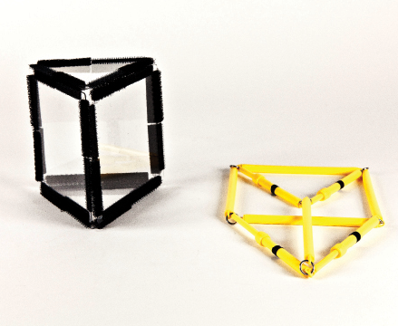 Photo shows a triangular prism constructed from Geometro tiles standing beside the corresponding rod model, now in 2-D, in Position 2.