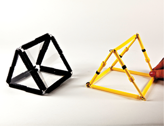 Photo shows a triangular prism constructed from Geometro tiles standing beside the corresponding rod model being held in 3-D, in Position 3, viewed from the right.