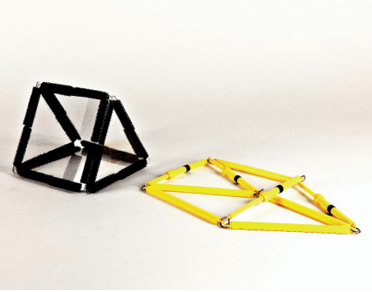Photo shows a triangular prism constructed from Geometro tiles standing beside the corresponding rod model, now in 2-D, in Position 3, view from left.