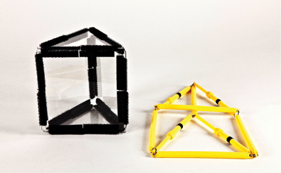 Photo shows a triangular prism constructed from Geometro tiles, Position 1, standing beside the corresponding rod model, now in 2-D.