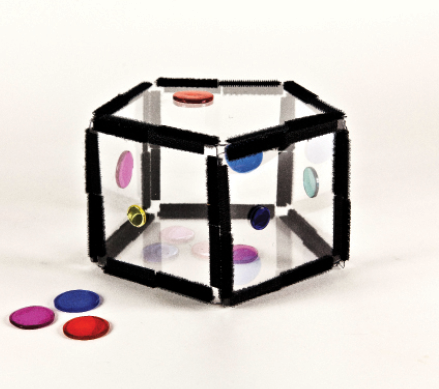 Photo shows a pentagon constructed from Geometro tiles with stickers, as described.