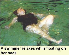A swimmer relaxes while floating on her back, Photo submitted by Camp Abilities.