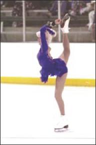 Jentry skates on her left leg as she holds her right leg behind her and up to her head.