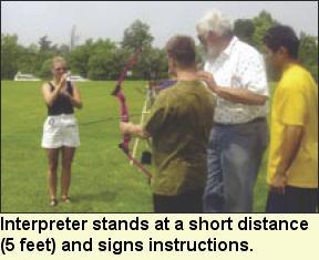Interpreter stands at a short distance (5 feet) and signs instructions, Photo submitted by Camp Abilities.