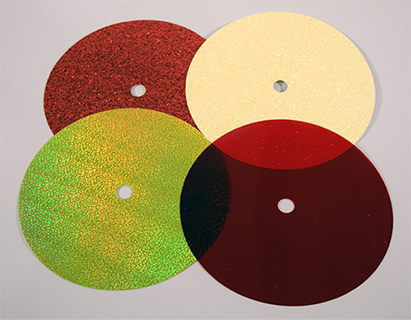Photograph of four low complexity overlays: red transparent, red sparkle, yellow holographic and yellow sparkle overlays.
