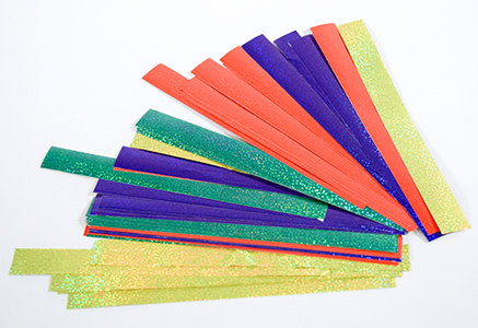 Photograph of red, blue, green, and yellow precut wide (8.5-by-0.875 in.) strips of holographic adhesive paper stickers.
