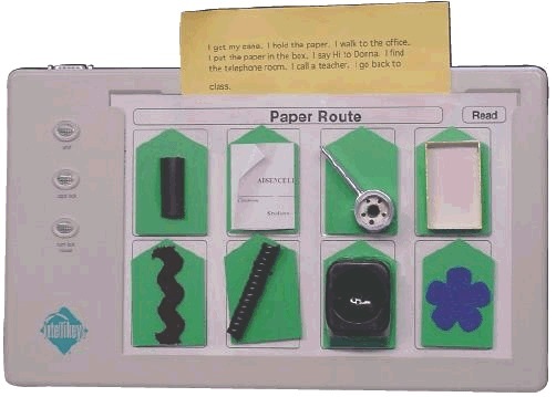 IntelliKeys story overlay:  Learner's paper route prepared by the California School for the Blind. Example: I get my cane. I hold the paper. I walk to the office. I put the paper in the box. I say Hi to Donna. I find the telephone room.  I call a teacher. I go back to class.