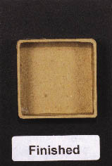miniature cardboard box adhered to the card