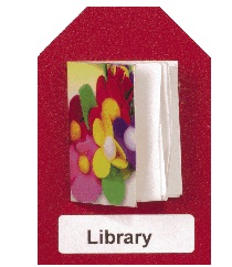 a miniature book in the center of the card