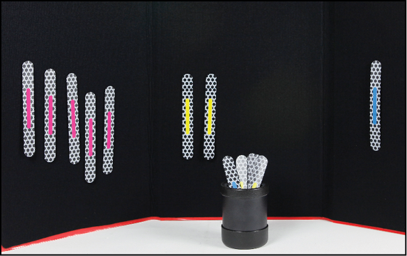 A black felt tri-fold board with eight attached Phase II Advanced MATCH STICKS: five pink-striped sticks set aside from two yellow-striped sticks and a blue-striped stick. A black plastic cylindrical cup in front of the board holds several more Phase II Advanced MATCH STICKS.