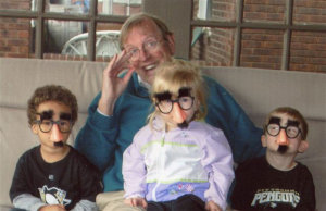 Richard Welsh with the little Grouchos (grandkids wearing Groucho Marx glasses, which include a large nose, eybrows, and a mustache)