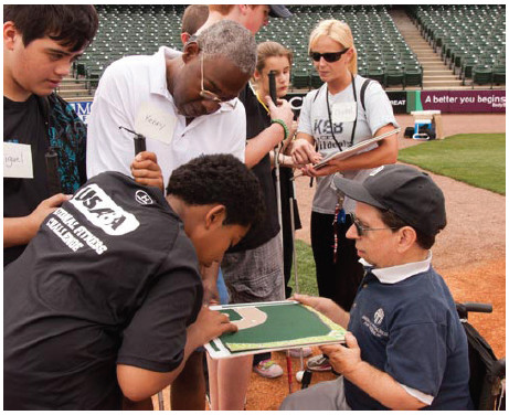 Students compare a baseball game board to a minor league baseball diamond