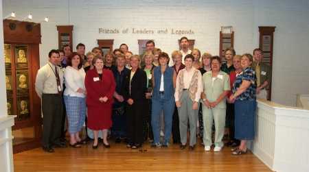 Workshop participants pose in front of the Hall of Fame display
