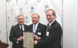 KY Senator Mitch McConnell presents APH Board Chair Jim Lintner and APH President Tuck Tinsley with the resolution he recently shared on the senate floor that heralds APH's 150 years of service.