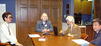 APH's Julia Myers sits at a table with Hiroshi Kawamura and two other Japanese guests