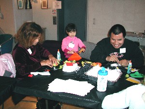 A family of three making masks.