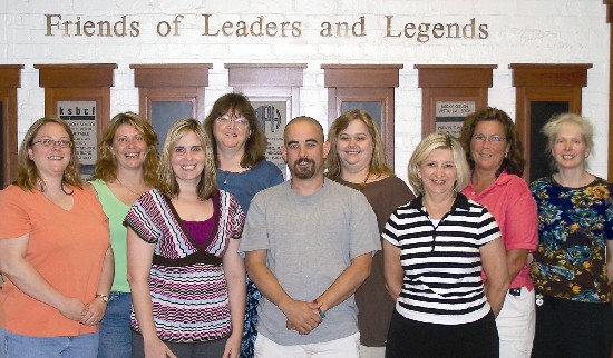 photo of the students and Dr. Trent standing in front of the Wall of Tribute in the Hall of Fame