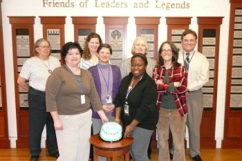 NIMAC staff and APH's Bob Brasher pose with the celebratory cake