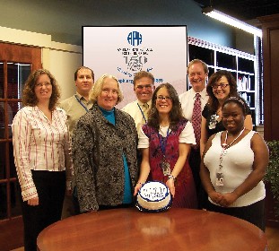 NIMAC staff and APH's Tuck Tinsley and Bob Brasher pose with the celebratory cake