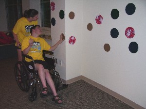 student in a wheelchair crossing the simulated rock climbing wall