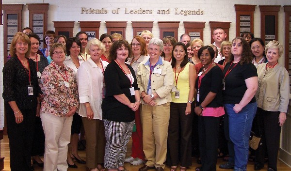 Photo of workshop participants posed in front of the Wall of Tribute of the Hall of Fame: Leaders and Legends of the Blindness Field