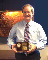 APH President Tuck Tinsley holding the award