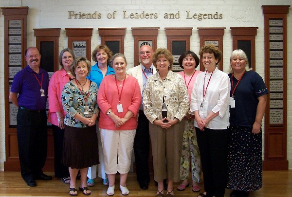Photo of workshop participants posed in front of the Wall of Tribute of the Hall of Fame: Leaders and Legends of the Blindness Field