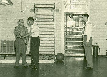 Russ Williams, right, head of the blind program at Hines V.A. Hospital, observes a lesson, circa 1950.