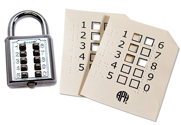 Photo of the Push-Button Padlock with two combination cards in large print and braille