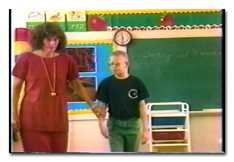 Scene from the video: A teacher and a low vision student in a classroom