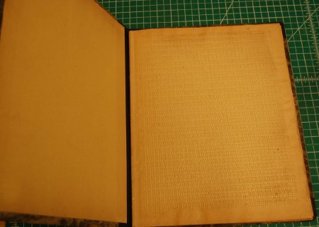 Open book, front leaf with rows of full braille cells (decorative)