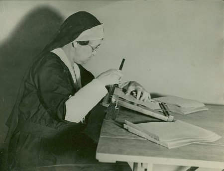 Nun using hole-punch, n.d.