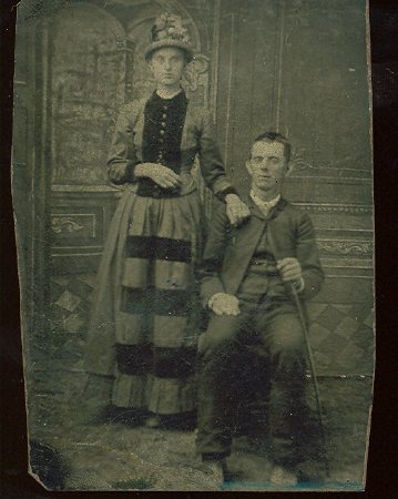 Woman and seated man with cane