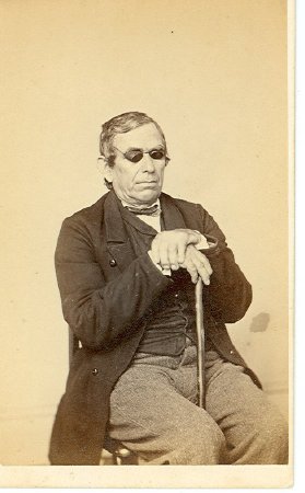 Seated blind man with cane