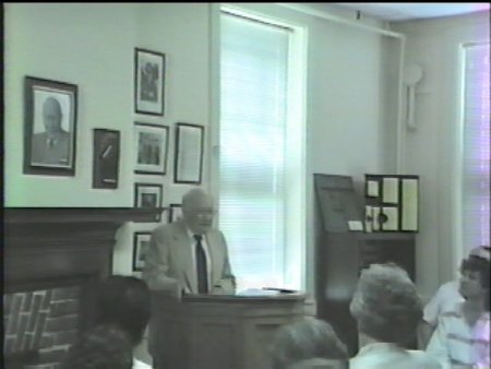 Screen grab from video, Warren Bledsoe at podium
