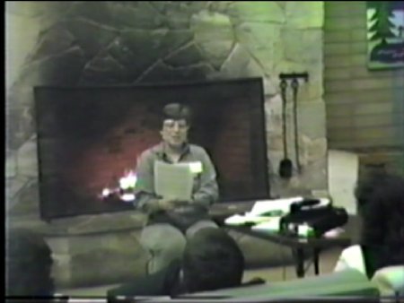 Screen grab, Dona Sauerburger in front of fireplace