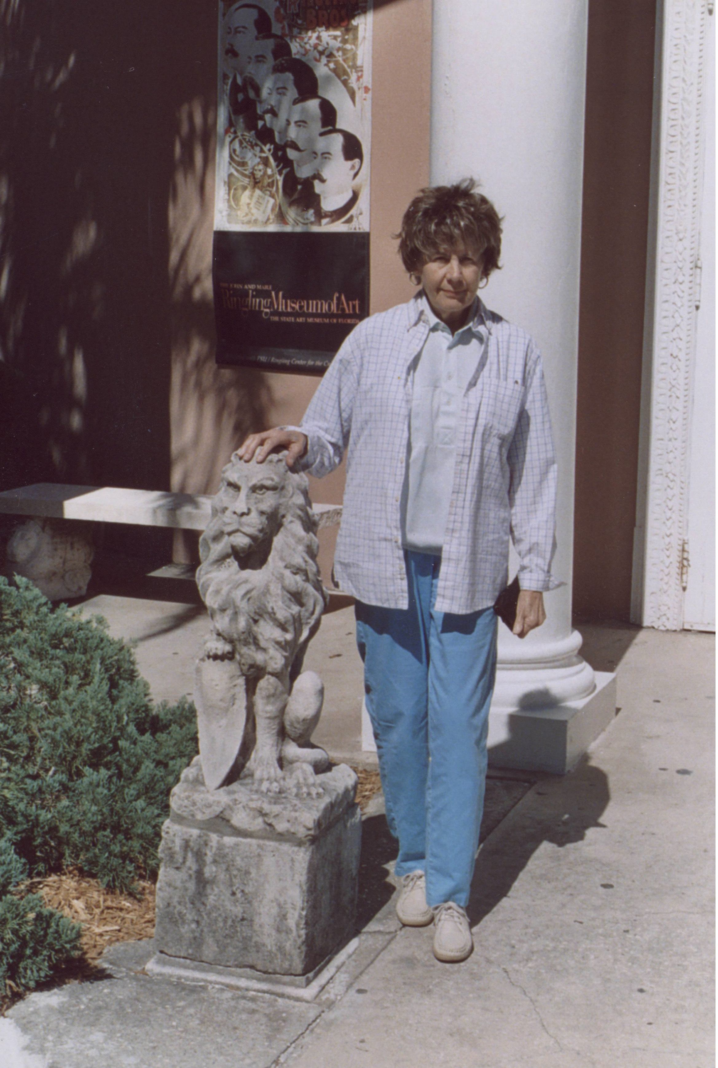 Lou Alonso standing next to a stone lion