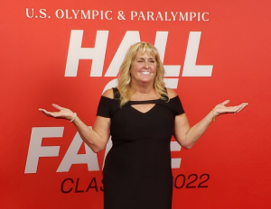 Trischa Zorn-Hudson attending the 2022 U.S. Olympic & Paralympic Hall of Fame ceremony. She is wearing a black evening gown and standing on the red carpet.